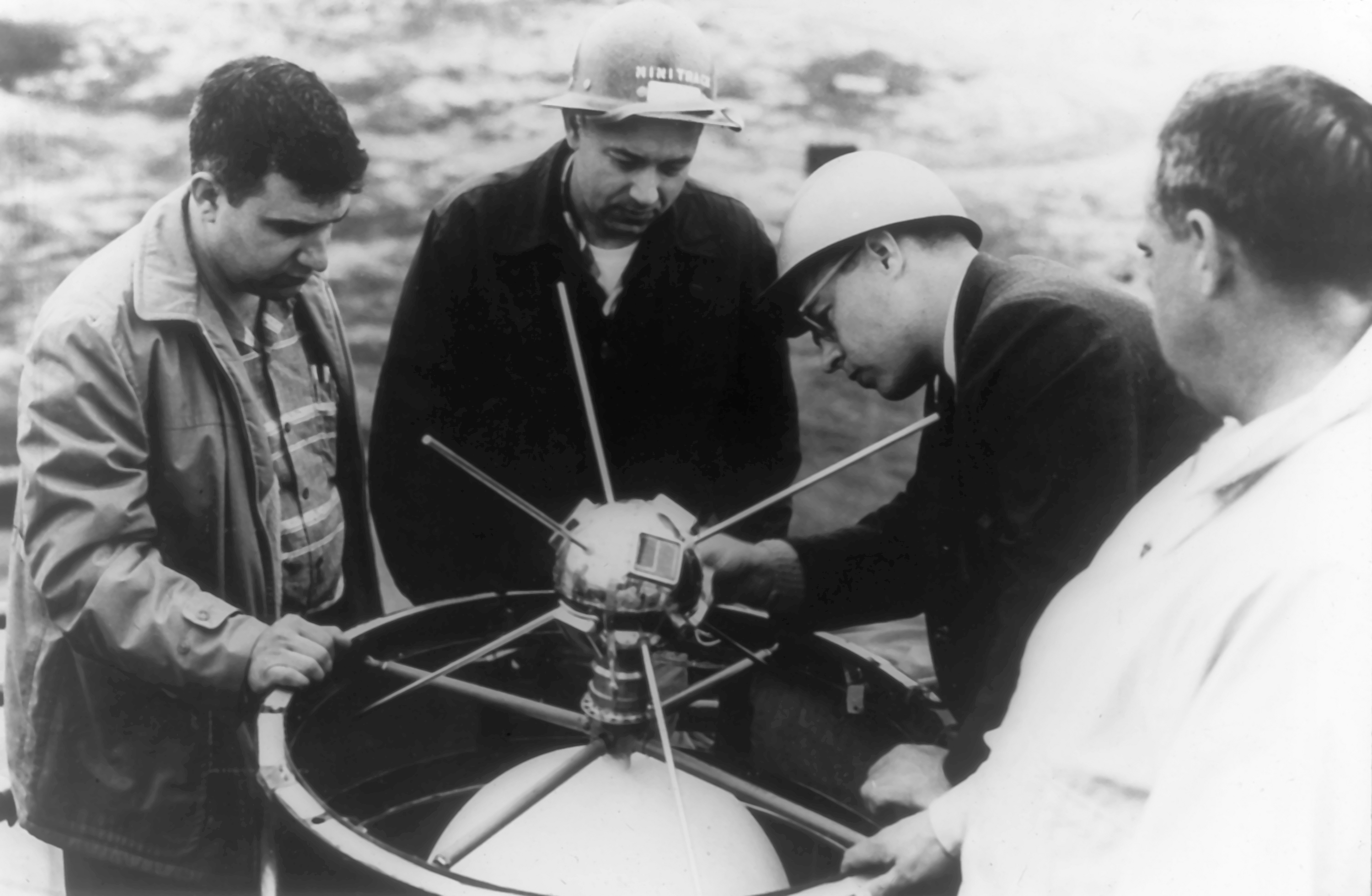 A team of Vanguard I scientists mount the satellite in the rocket.  (Photo/Image provided courtesy of the Naval Research Laboratory.)